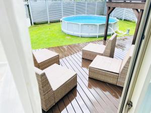 a patio with two chairs and a swimming pool at MORITO Funny house in Hayama