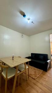 a living room with a table and a couch at Seawind Condominium Sasa, Davao City in Davao City