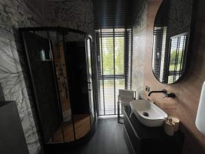 a bathroom with a sink and a mirror at Boszkowo Horizon Park apartament 24 in Boszkowo-Letnisko +13 photos