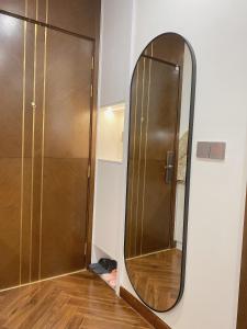 a mirror on a wall next to a door at Cozy studio Apartment in Diamond Crown Hai Phong 1218A in Hai Phong