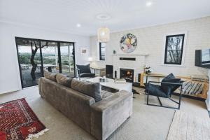 a living room with a couch and a fireplace at Kingsgate Farm-Stay in McLaren Vale