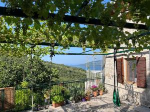 a view from the balcony of a house with plants at Artist's House on the Mountain in Zelenika