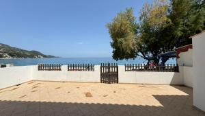 a view of the water from a building with a fence at Sea View in Kámpos