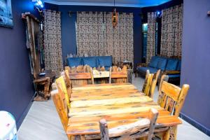 a dining room with a wooden table and chairs at Love House in Dodoma