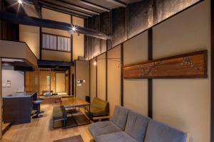 a living room with a couch and a table at Kyo no oozora SAIKA in Kyoto