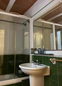 a bathroom with a sink and a glass shower at Cal Blasi in Montblanc
