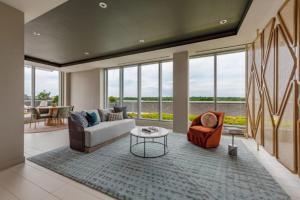 a living room with a couch and a table at Clarendon 1BR w Gym WD Pool nr Metro WDC-381 in Arlington