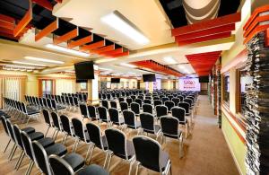 an empty hall with chairs and a stage at Apartmán Liptov - Hotel Bešeňová in Bešeňová +23 photos