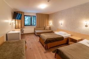 Ένα ή περισσότερα κρεβάτια σε δωμάτιο στο Hotel Karupesa