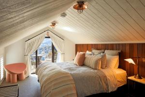 a bedroom with a large bed and a window at Newton Heights in Akaroa