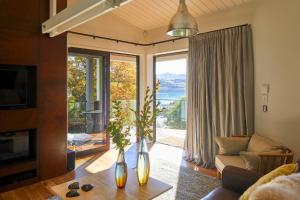 a living room with a couch and a large window at Newton Heights in Akaroa