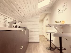 a kitchen with a counter and stools in a room at G-house in Parma