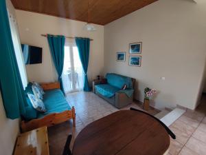 a living room with a couch and a table at Christianna Studios in Nikiana