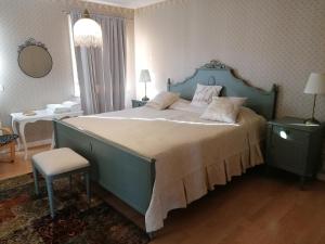 a bedroom with a large bed with a blue headboard at Hudiksvall Apartment Service # 4 in Hudiksvall