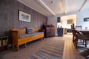 a living room with a couch and a table at Tind seaside cabins in Tind