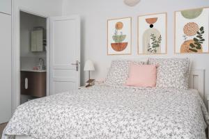 a bedroom with a bed with a pink pillow at Apart Merryland Paris Châtelet in Paris