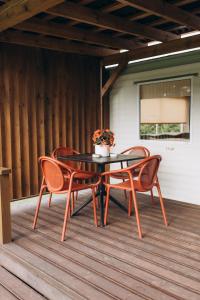 a table and four chairs on a patio at Atvases in Pērkone
