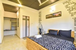 a bedroom with a bed and a wall with writing on it at Black Stone Villa in Lonavala +20 photos