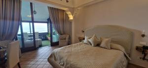 a bedroom with a bed and a view of a balcony at Albergo La Conca Azzurra in Conca dei Marini