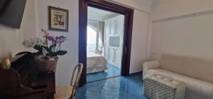 a room with a living room with a couch and a mirror at Albergo La Conca Azzurra in Conca dei Marini