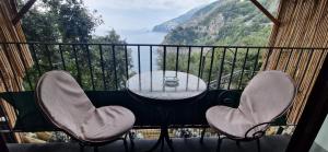 a table and chairs on a balcony with a view at Albergo La Conca Azzurra in Conca dei Marini