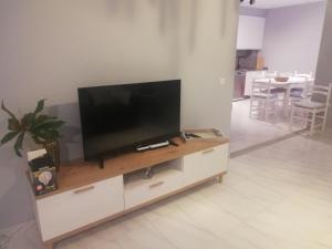 a flat screen tv sitting on top of a white entertainment center at Areos in A Pobra do Caramiñal +5 photos