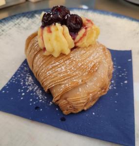 a dessert with fruit on top of a blue plate at Albergo La Conca Azzurra in Conca dei Marini