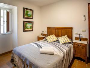 a bedroom with a bed with two pillows on it at QUINTA do SOUTO BARCIADEMERA in Barciademera +107 photos