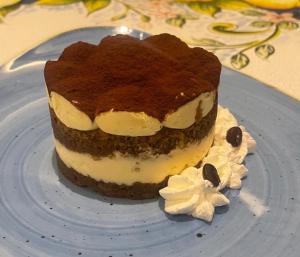 a piece of cake sitting on a blue plate at Albergo La Conca Azzurra in Conca dei Marini