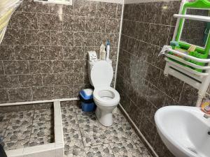 a bathroom with a toilet and a sink at magic home in Boz-Beshik