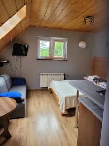 a small room with a bed and a table at Jelonek Zawoja in Zawoja