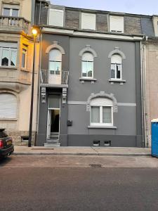 a gray building with windows on a city street at BRIGHT SINGLE ROOM IN GUEST House in Luxembourg