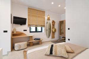 a bedroom with a bed and a flat screen tv at Gemilos Harmony in Adamas +23 photos