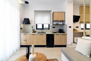 a kitchen with white walls and wooden cabinets at Gemilos Harmony in Adamas