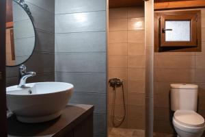 a bathroom with a sink and a toilet at Olive Garden Toroni in Toroni +19 photos