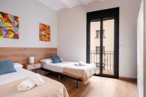 Posteľ alebo postele v izbe v ubytovaní Fira Barcelona Apartment