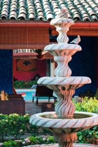 a large stone fountain in front of a building at Hotel Casa del Consulado in Granada