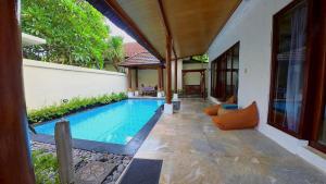 a swimming pool in the middle of a house at Privat Pool villa at kuta in Kuta