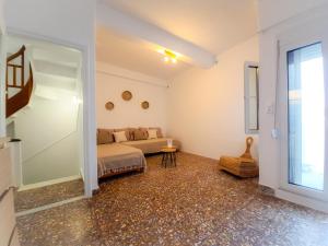 a living room with a couch and a window at Sophellie's place Skiathos in Skiathos