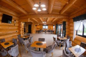 a dining room with tables and chairs in a cabin at Bucovina Exclusiv in Vama