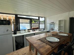 a kitchen with a wooden table in a trailer at Logement agréable sur Le Teich in Le Teich