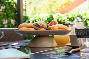 a plate of donuts sitting on a table at Vatican Boutique Apartment with large Terrace in Rome