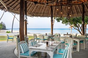 a restaurant with tables and chairs on the beach at SAii Phi Phi Island Village in Phi Phi Islands