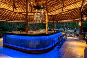 a bar under a straw roof at a resort at SAii Phi Phi Island Village in Phi Phi Islands