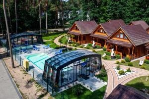 an aerial view of a house with a pool at Bajkowe Domki in Pobierowo +41 photos