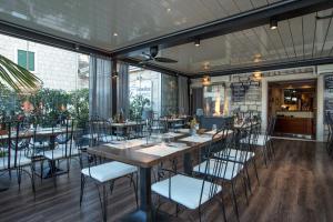 a restaurant with a long table and chairs at Pansion Kamenar 2 in Primošten +6 photos