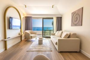 a living room with a couch and a view of the ocean at Exlusive Villa M -Baska Voda in Baška Voda
