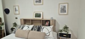 a living room with a couch and pillows at EUR Fenix Apartment free parking family in Rome