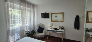a bedroom with a bed and a desk and a mirror at EUR Fenix Apartment free parking family in Rome