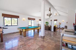 a living room with a pool table in it at UFitness Retreat Guesthouse in Vila Real de Santo António